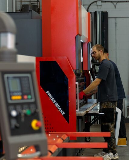a man working on a machine in a factory